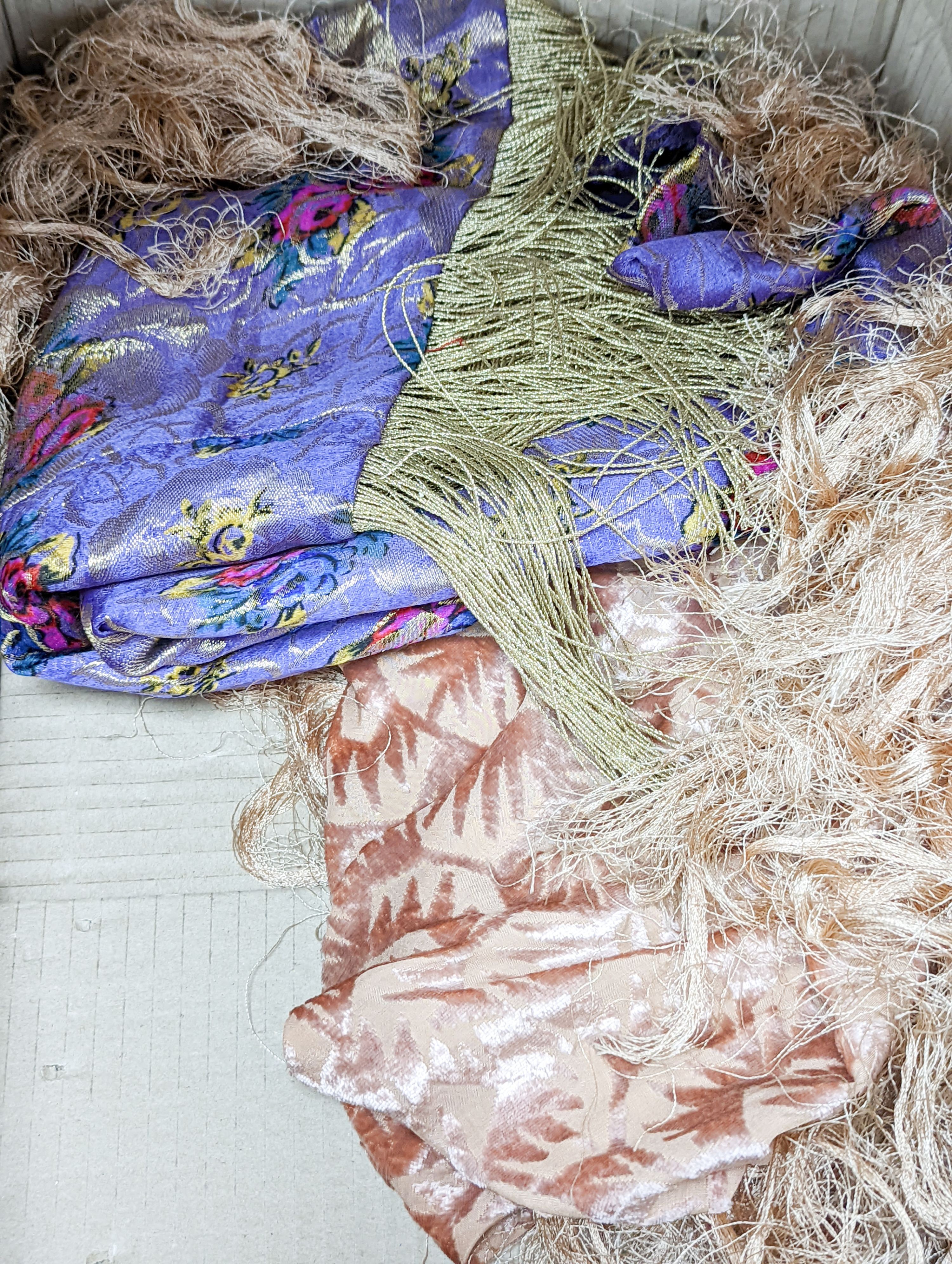 A 19th century silk woven shawl, a 1930's cut velvet shawl, a printed crepe de chine shawl, a black and gold lurex shawl and a multicoloured lurex stole (5)